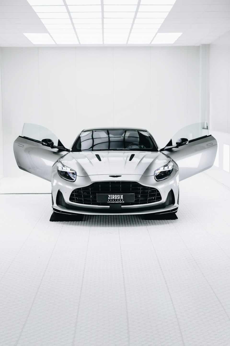 Luxury sports car with open doors in a white studio.